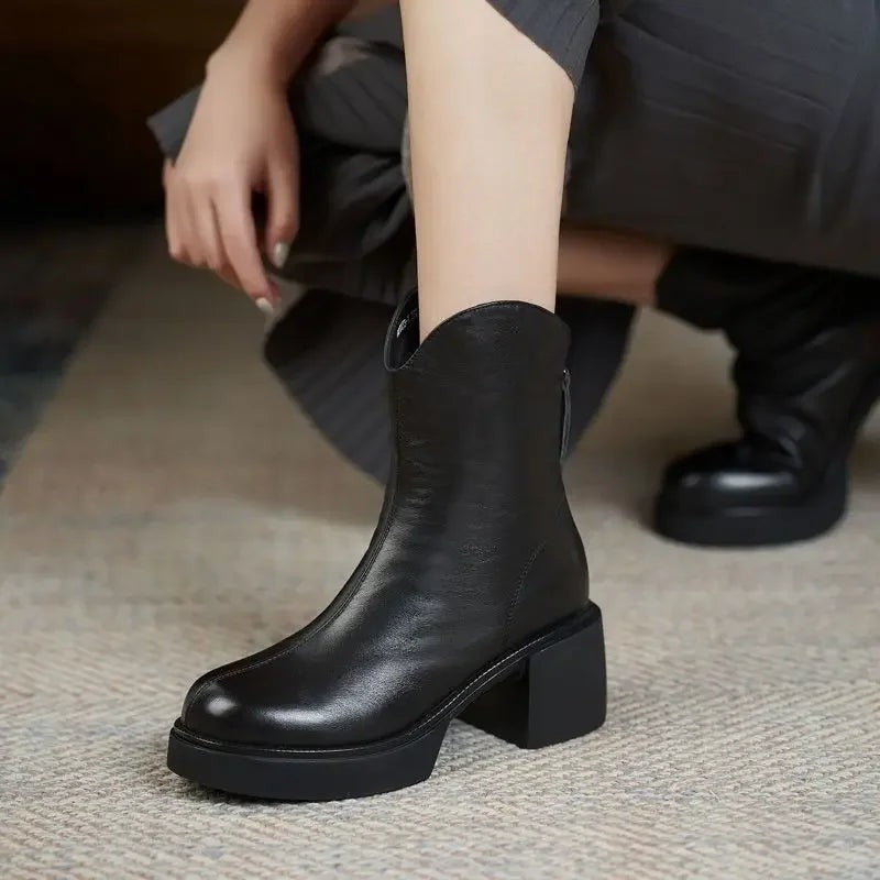 Black leather Chelsea boots featuring chunky heel and platform sole