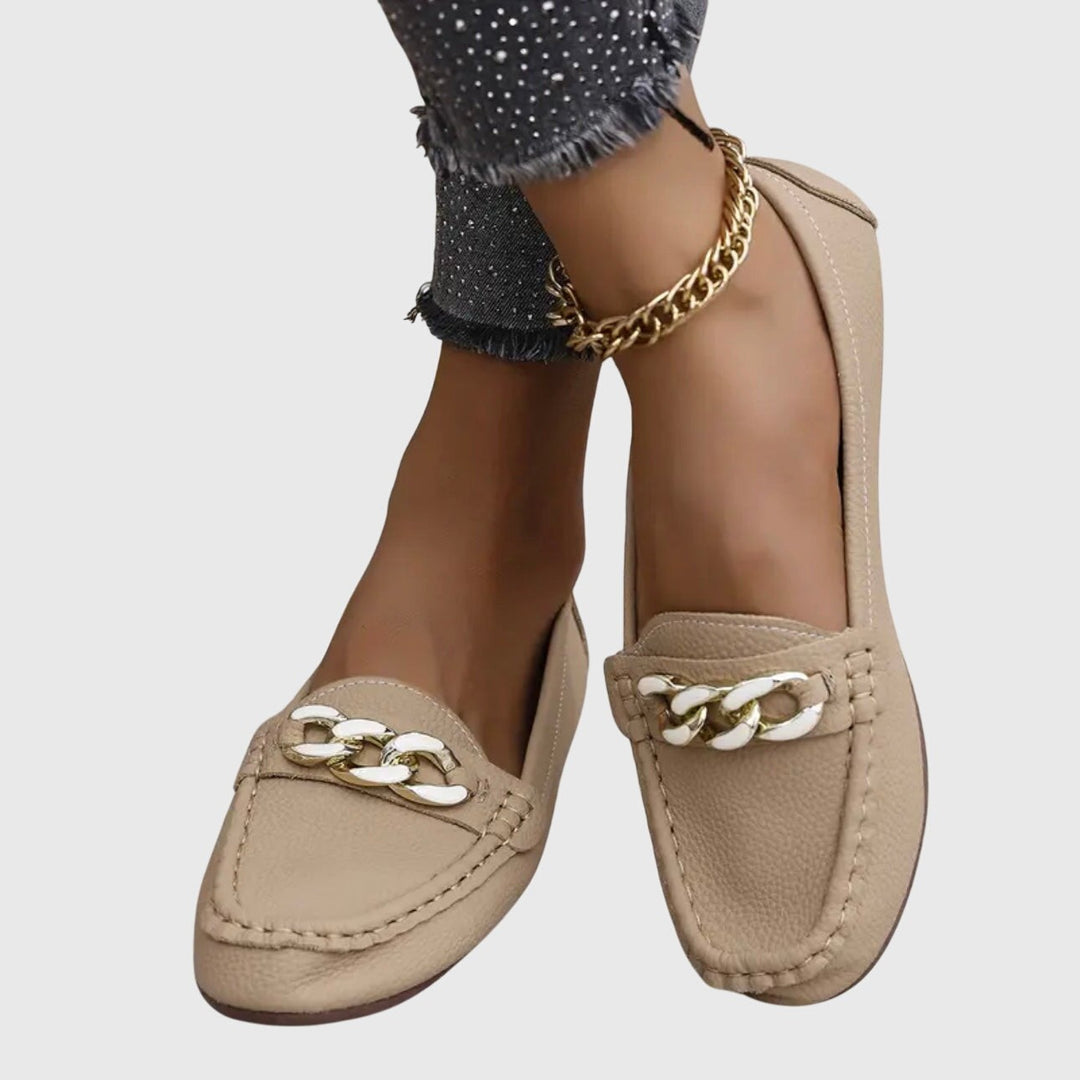 Beige loafers with white gold chain trim, styled with sparkly denim
