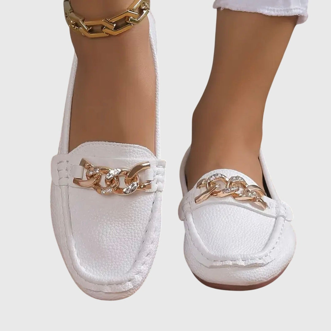 White leather loafers with rhinestone gold chain buckle, close front view