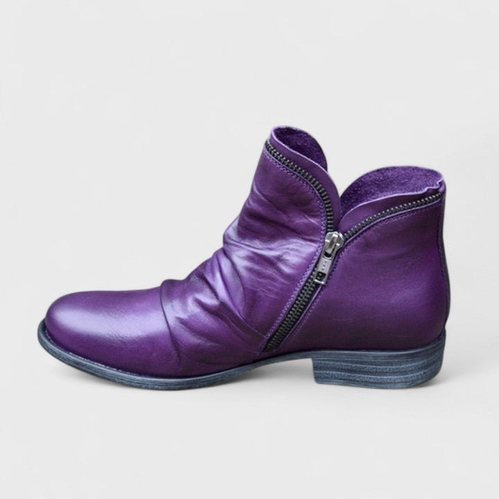 Purple leather ankle boot with ruched detail and exposed side zip