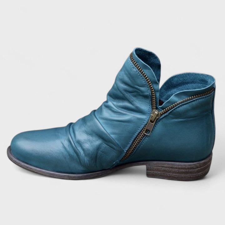 Teal leather ankle boot with ruched vamp and bronze side zip