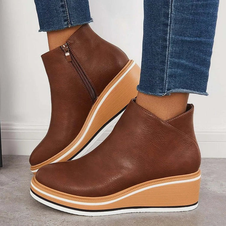 Brown leather ankle boots with rose gold zipper and platform wedge sole