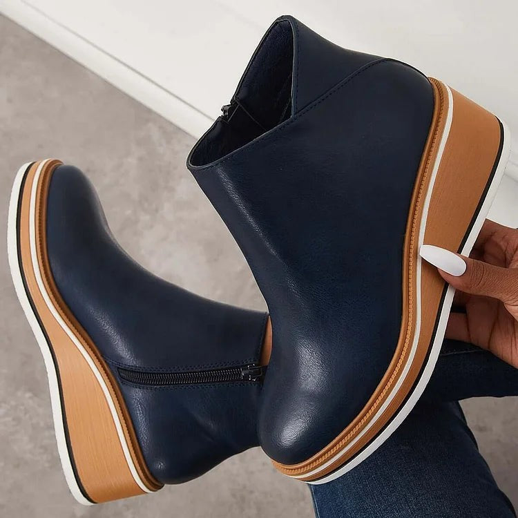Navy leather wedge ankle boots showing chunky platform sole detail