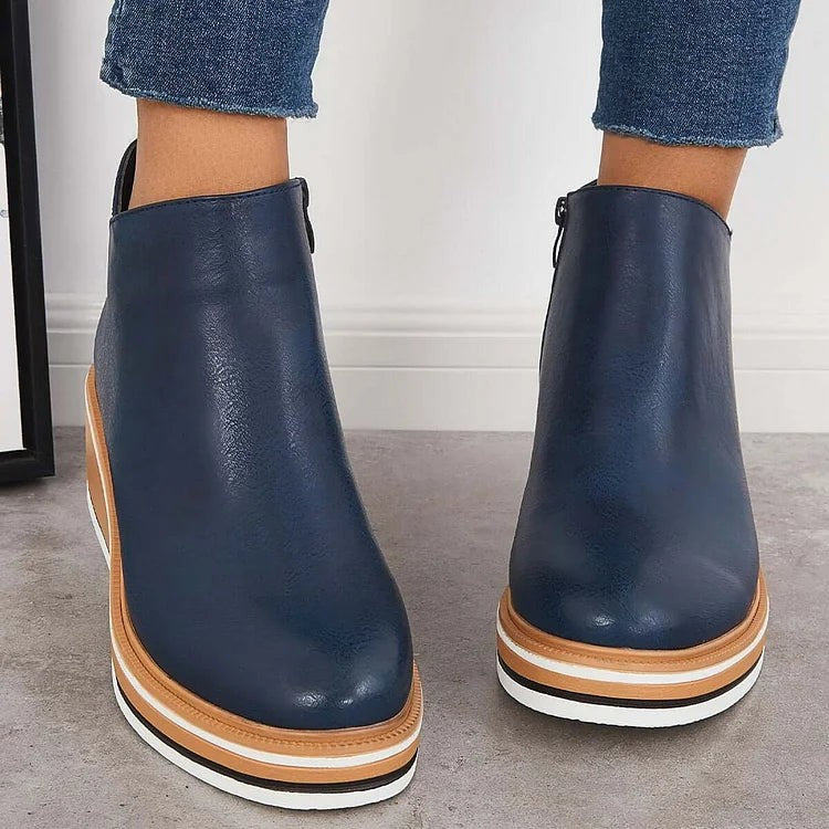 Back view of navy blue ankle booties with contrast platform wedge heel
