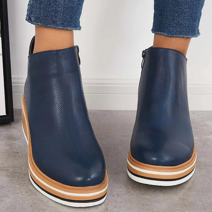 Back view of navy blue ankle booties with contrast platform wedge heel