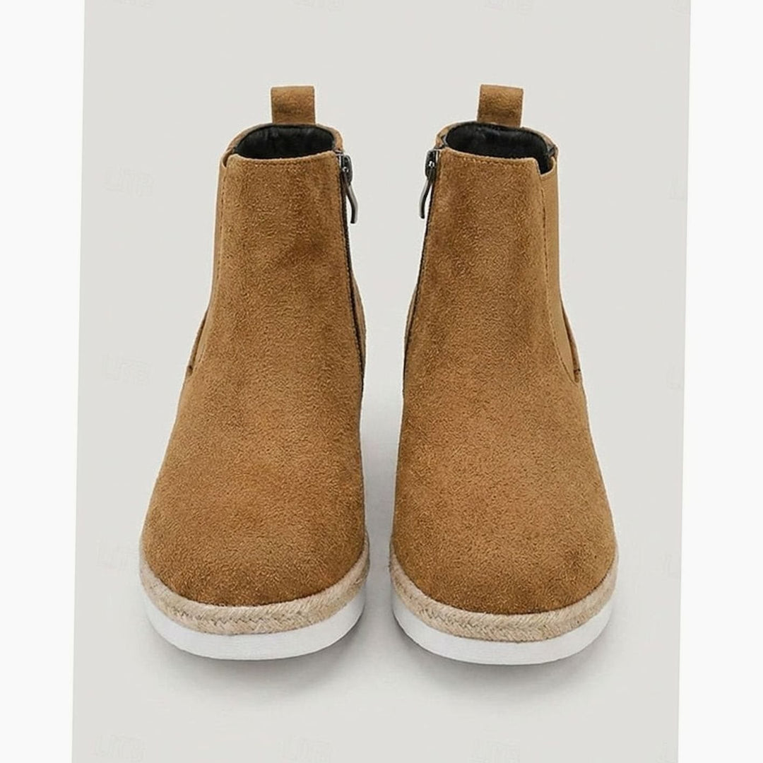 Rear view of tan suede Chelsea booties showing elastic side panels