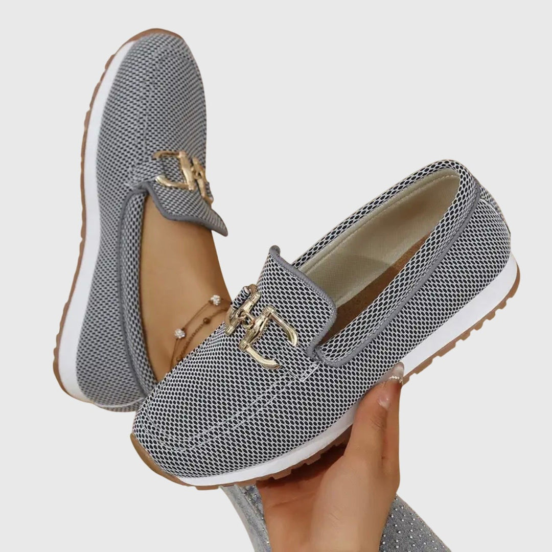 White knit loafers with gold horsebit trim and cushioned platform sole