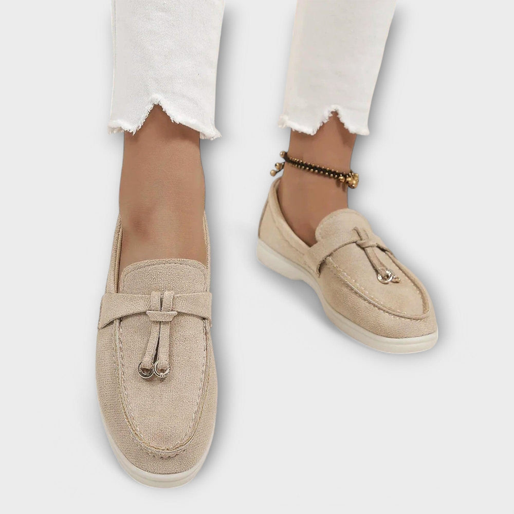 Beige suede slip-on loafers styled with cropped white jeans