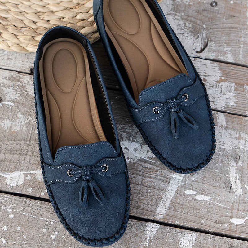 Navy blue suede loafers with tan cushioned insole shown from above