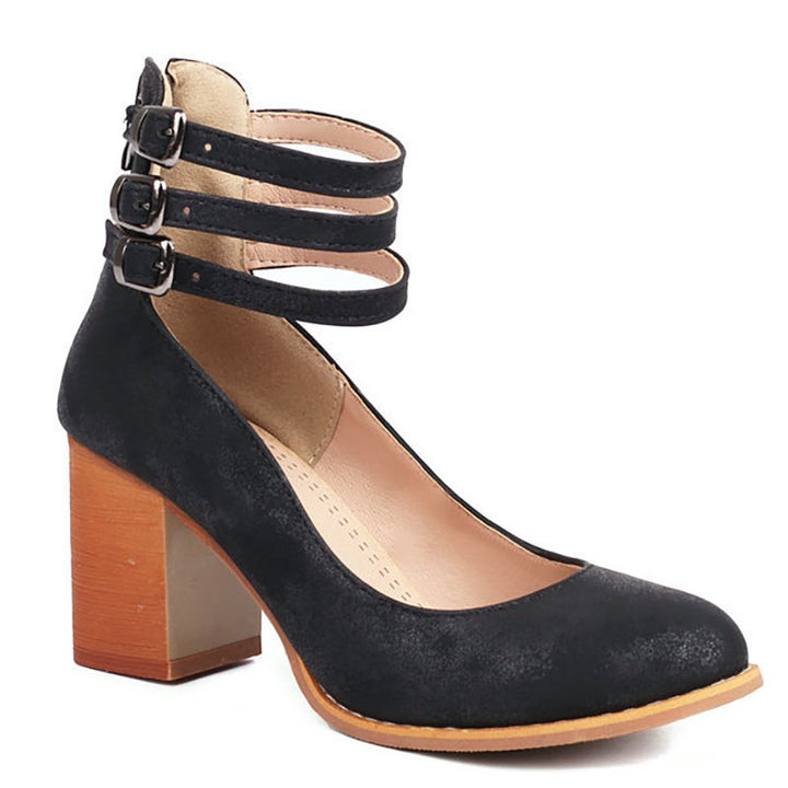Black suede ankle-strap pumps featuring triple buckles and side zipper closure