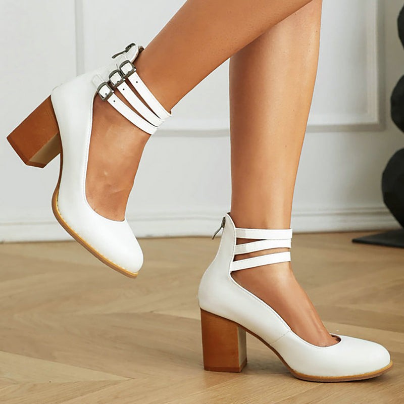 White leather ankle-strap pumps with triple buckle straps and chunky block heel