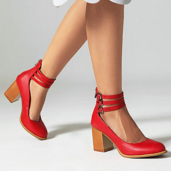 Red leather block-heel pumps with triple buckled ankle straps, side view