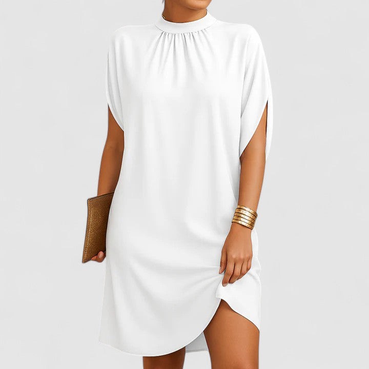 White mock neck shift dress featuring split sleeves and tulip hem