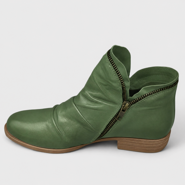 Sage green leather ankle boot with ruched texture and antique zipper trim