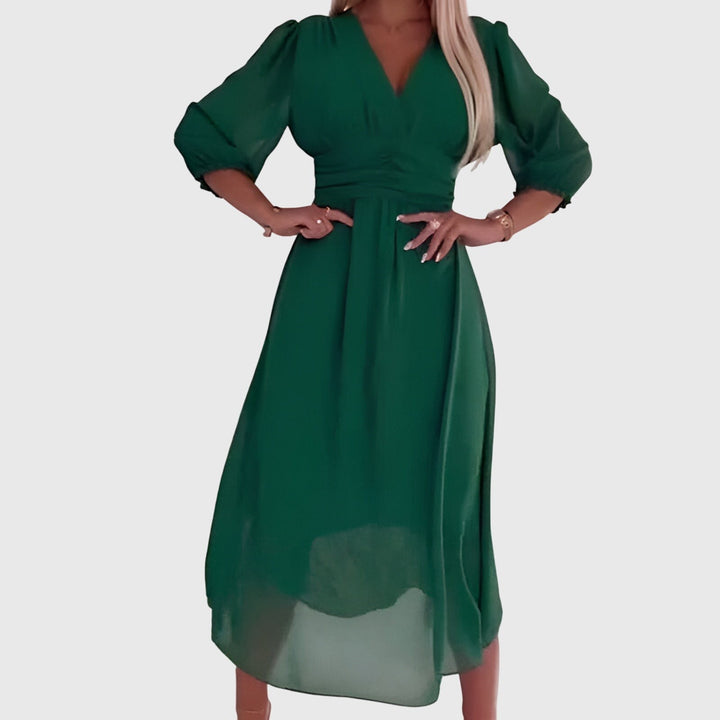 Emerald green chiffon dress with V-neckline and three-quarter sleeves