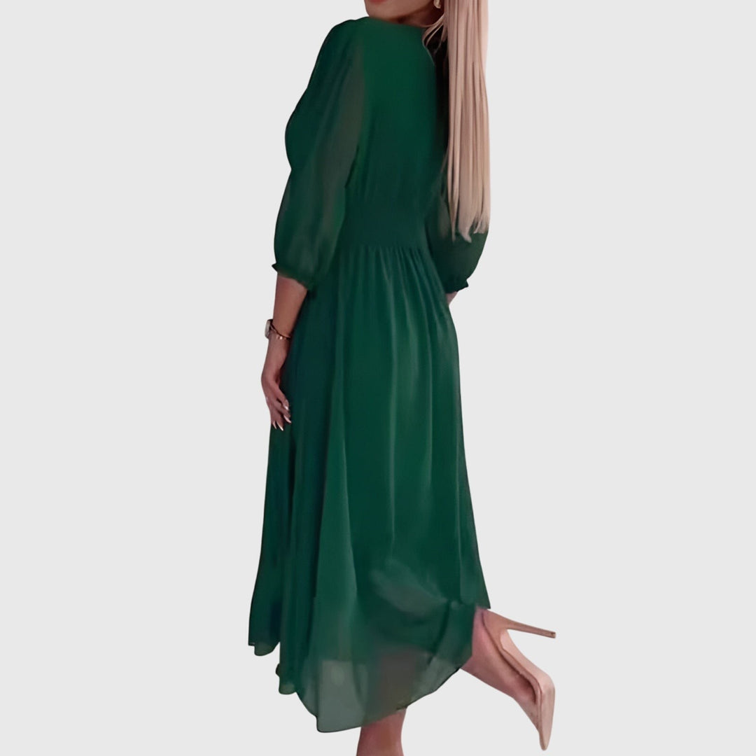 Side view of green chiffon midi dress showing flowy silhouette and puff sleeves