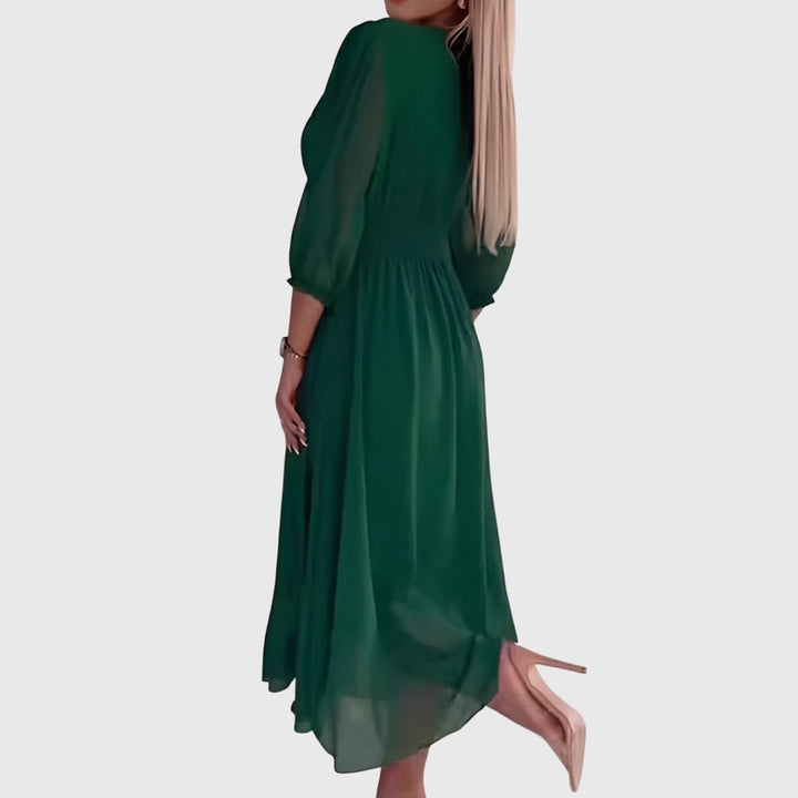 Side view of green chiffon midi dress showing flowy silhouette and puff sleeves