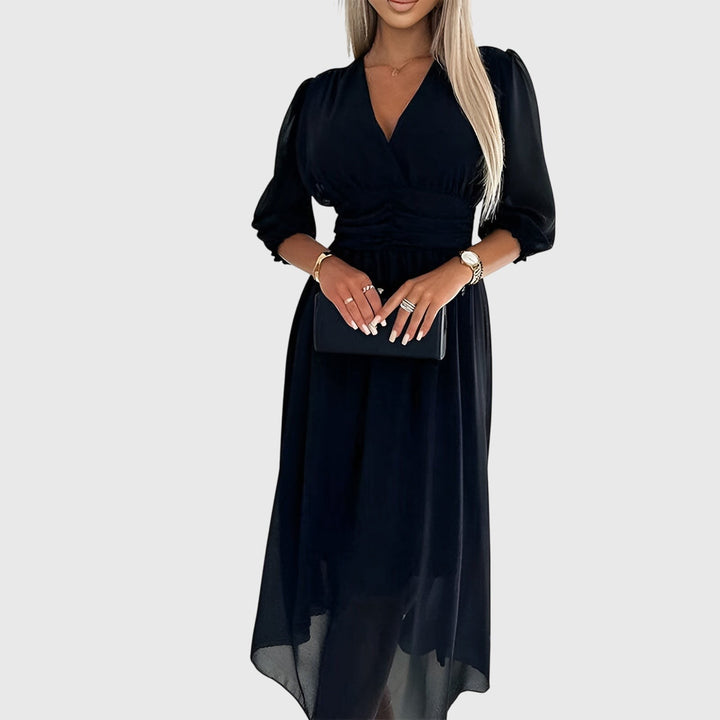 Black chiffon midi dress with V-neckline paired with matching clutch