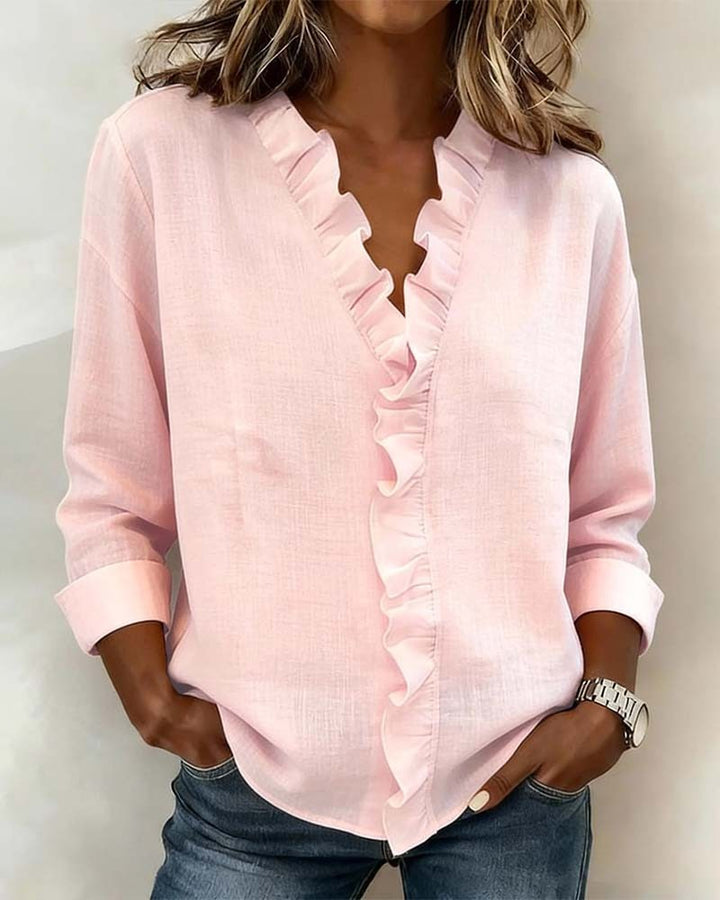 Blush pink ruffle V-neck blouse with long sleeves and cuffed hem