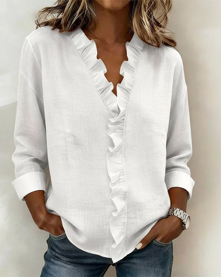 White ruffle V-neck blouse featuring long sleeves and linen-look fabric