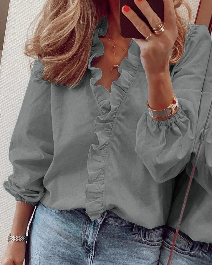 sage green ruffled V-neck blouse with puff sleeves