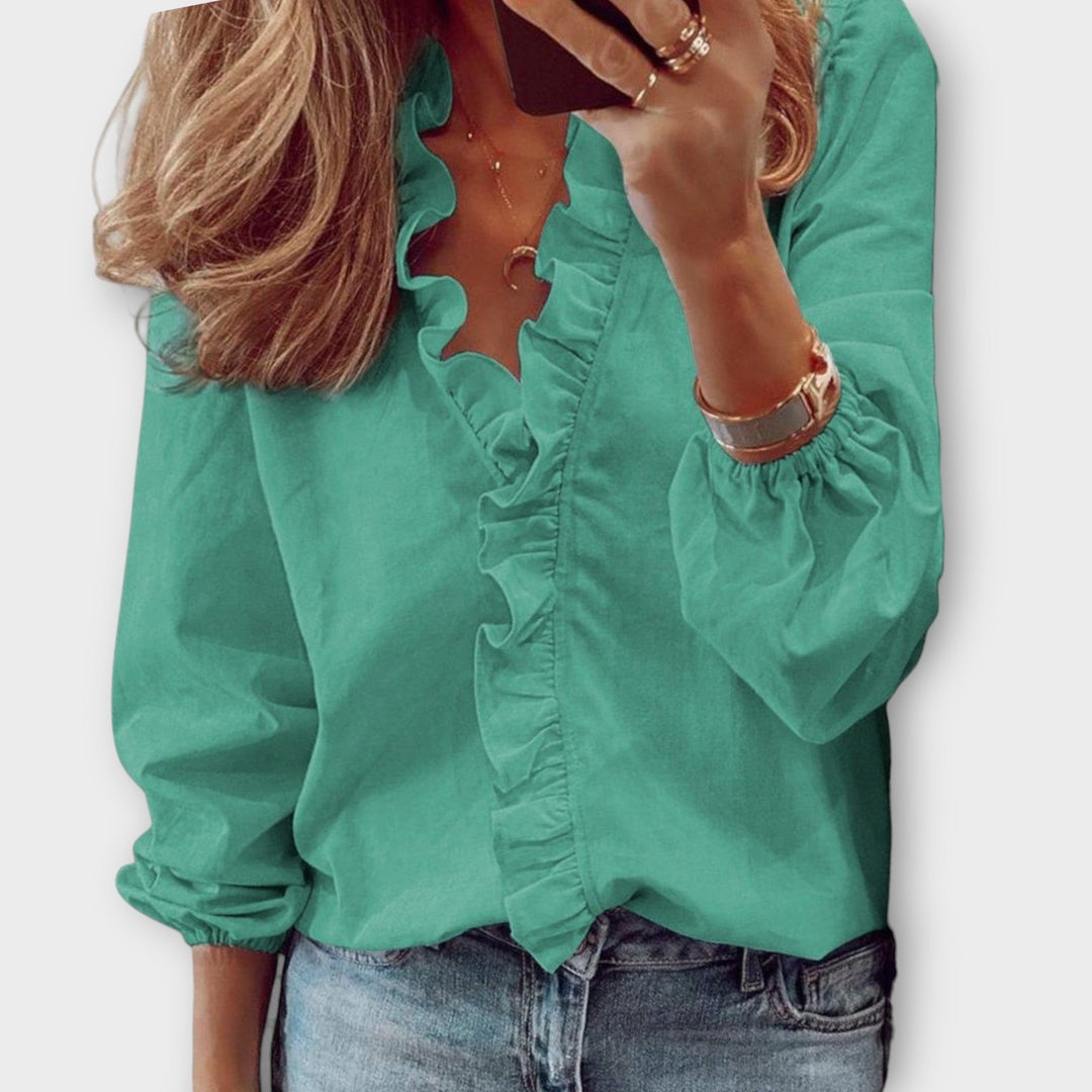 Emerald green ruffled V-neck blouse with balloon sleeves and elastic cuffs
