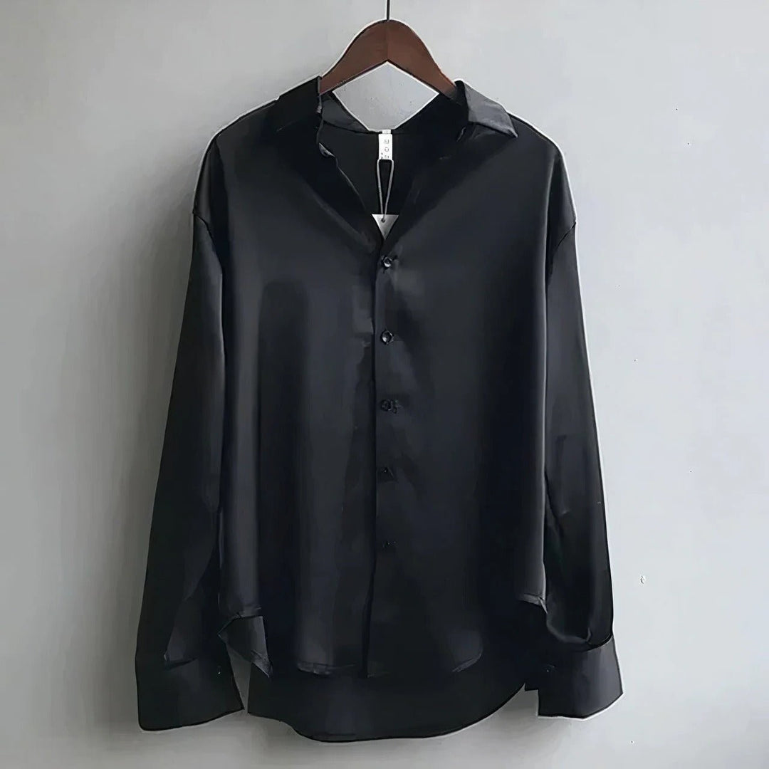 Black satin long-sleeve blouse with button front, shown on hanger