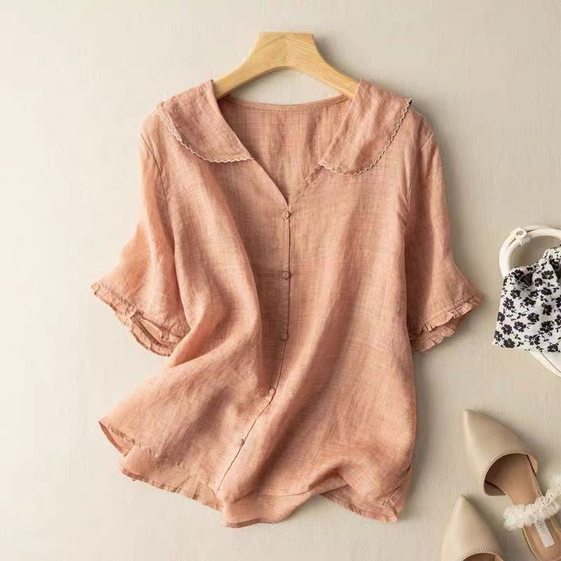 Pale pink linen blouse featuring ruffled sleeves and scalloped collar