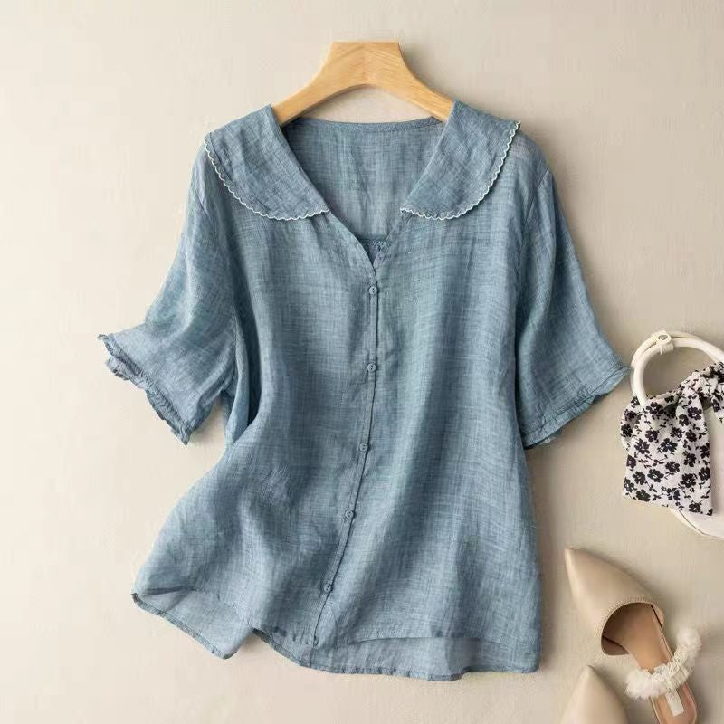 Dusty blue linen blouse with ruffled short sleeves and scalloped collar detail