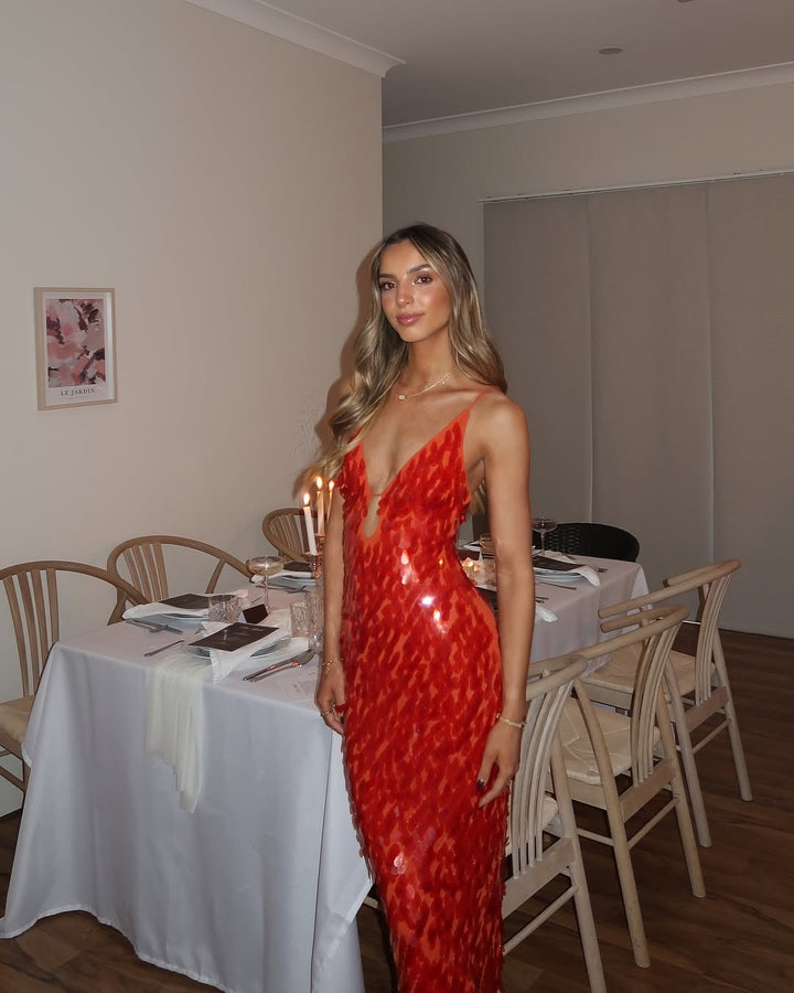 red sequin maxi dress with deep V-neck styled at dinner table setting