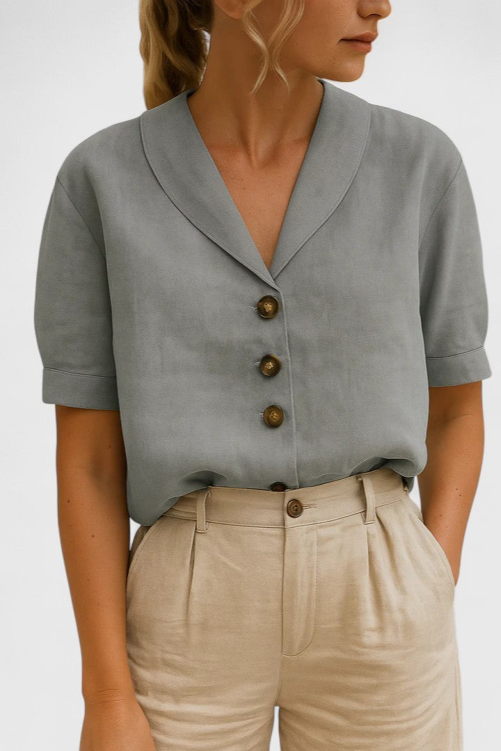 Sage green short-sleeve blouse featuring shawl collar and tortoiseshell buttons