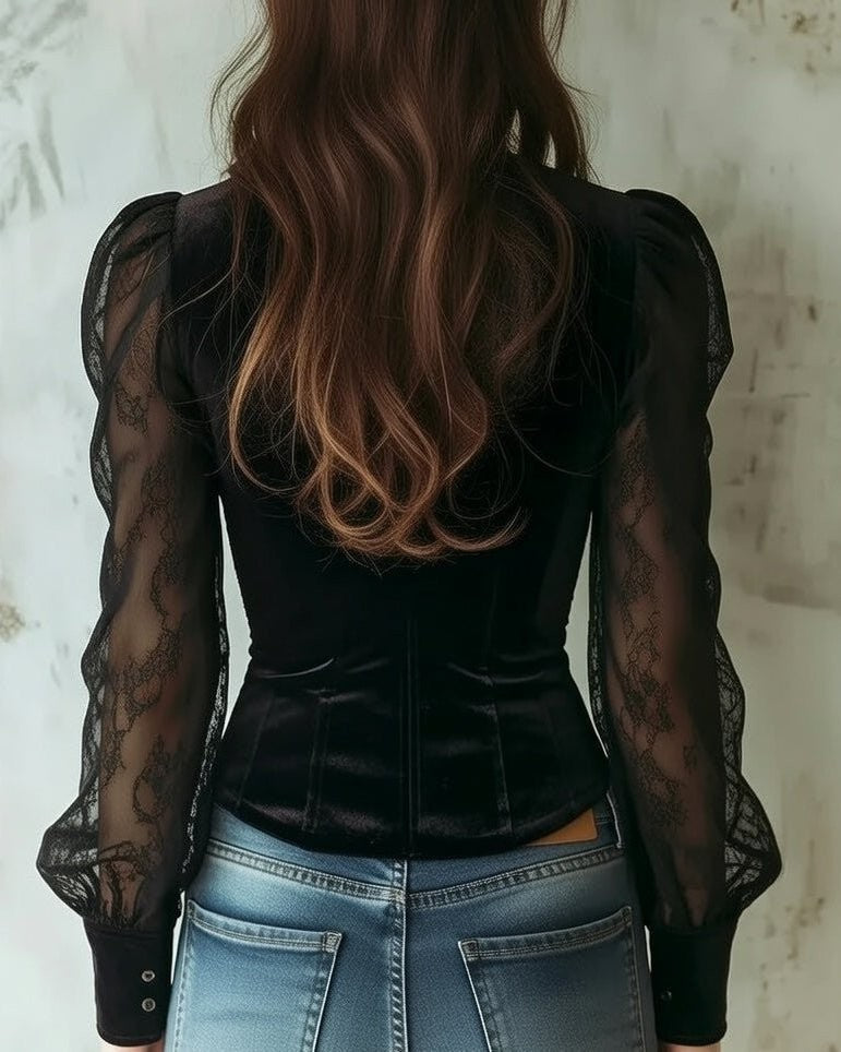 Back view of black velvet corset top showing sheer lace sleeve pattern