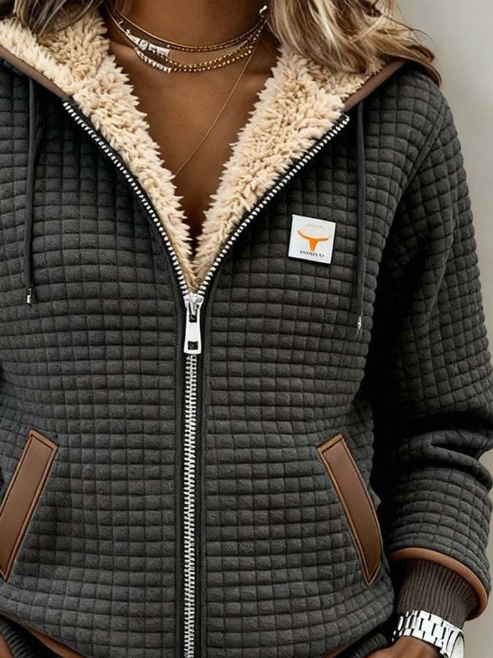 Close-up of sherpa hood collar on gray quilted zip-up jacket