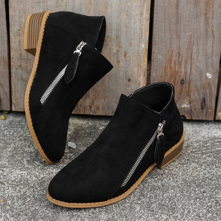 Black suede ankle boots with silver side zip and stacked heel
