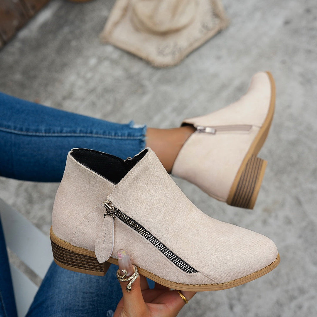 Beige suede ankle boots featuring pointed toe and low block heel