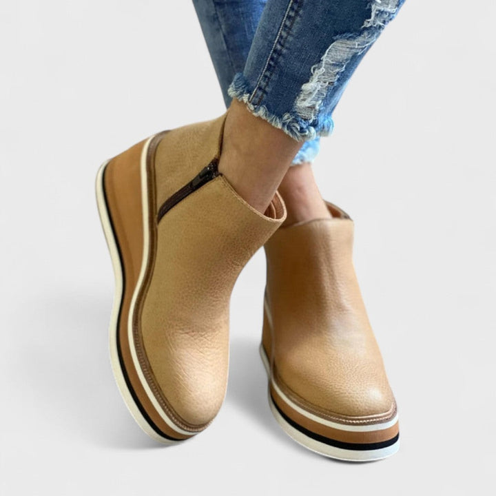 tan leather platform wedge booties worn with cropped denim jeans