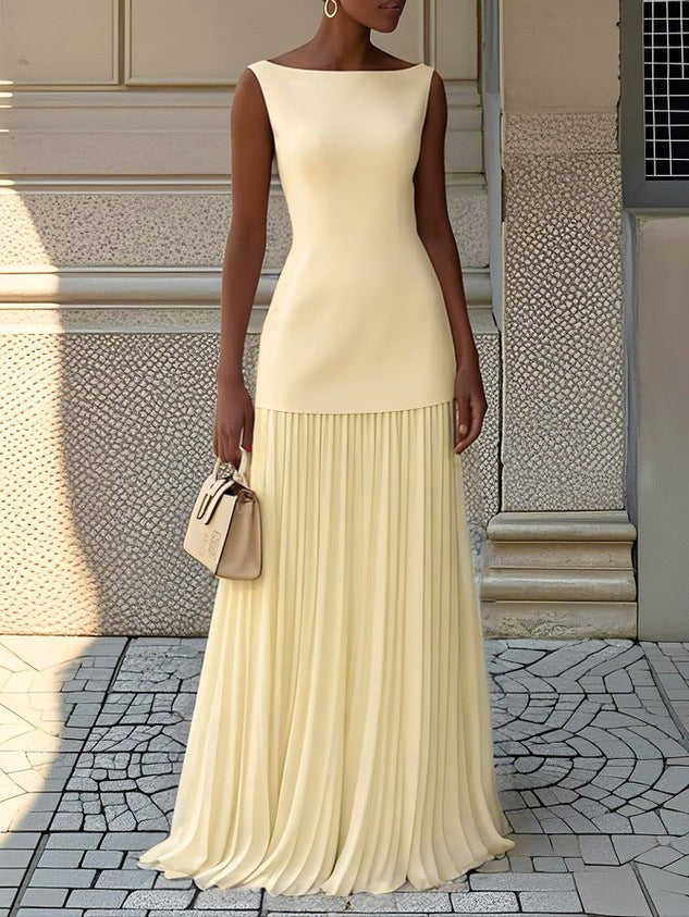 Pale yellow sleeveless maxi dress featuring fitted bodice and pleated skirt