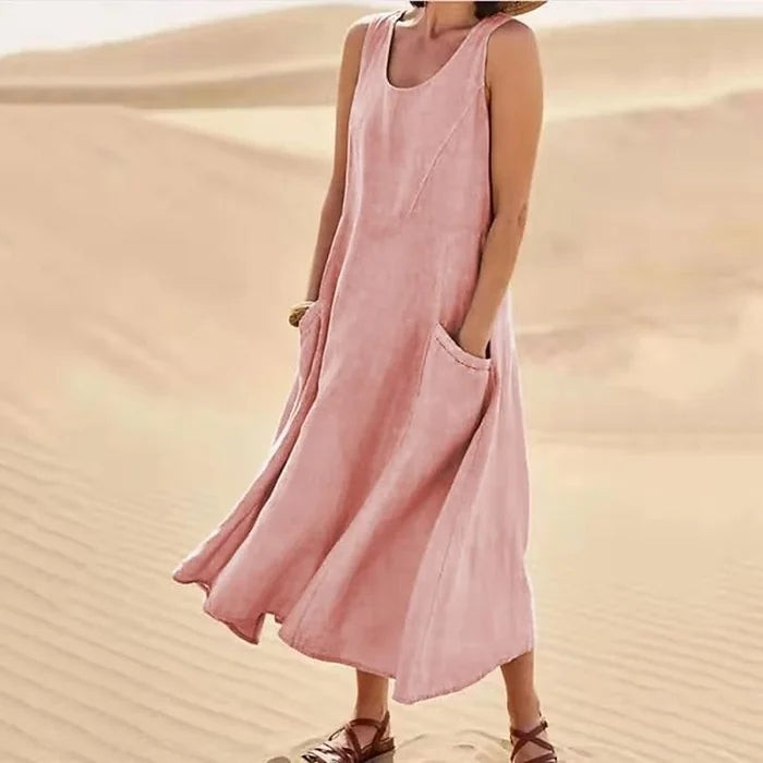 Pink sleeveless linen maxi dress with side pockets, worn in desert setting