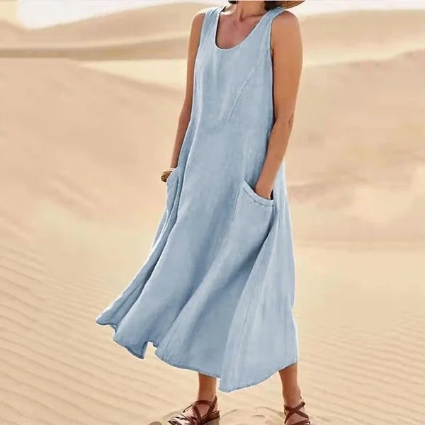 Pale blue sleeveless linen midi dress with side pockets on model