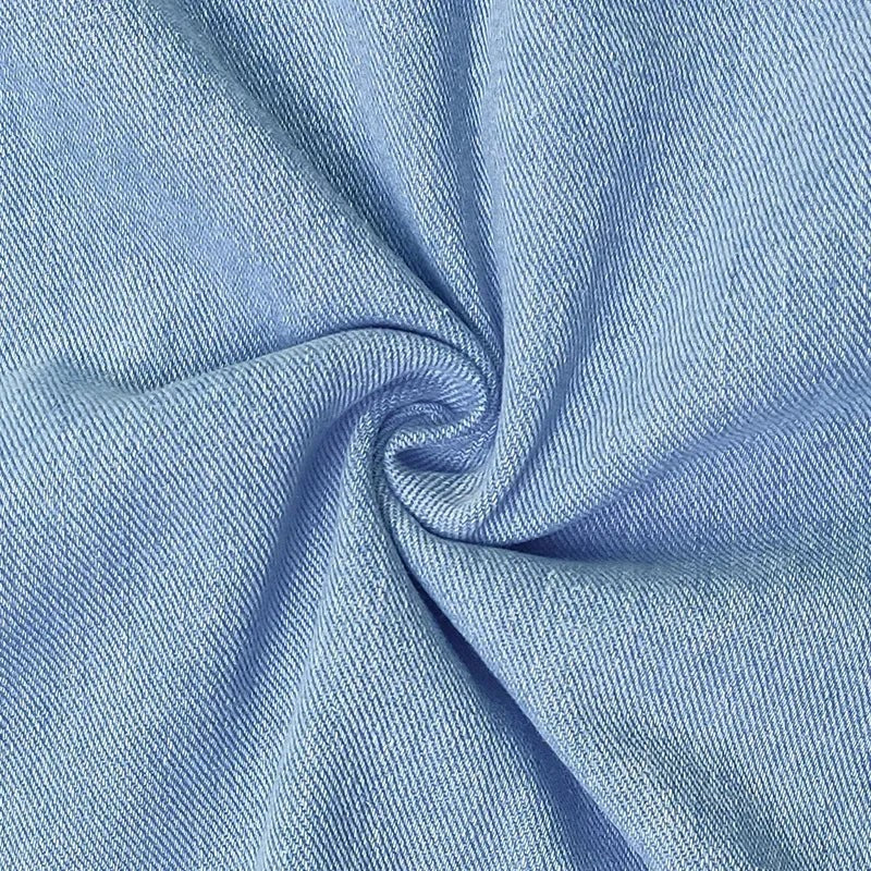 Close-up of light blue denim fabric showing soft twill texture