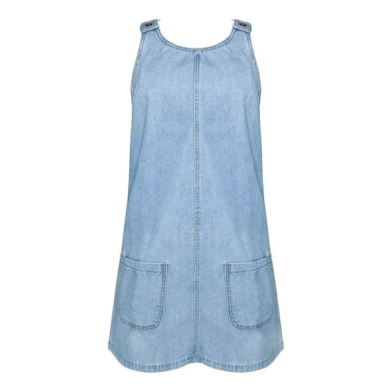Light wash denim overall dress with patch pockets on plain background