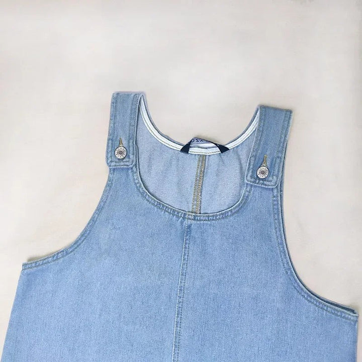 Close-up of denim dress neckline and adjustable shoulder straps