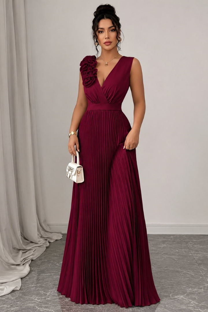 burgundy sleeveless evening gown with floral shoulder applique and pleated skirt
