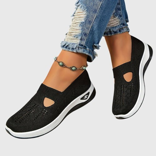 Black mesh slip-on sneakers with cutout accent and white platform outsole