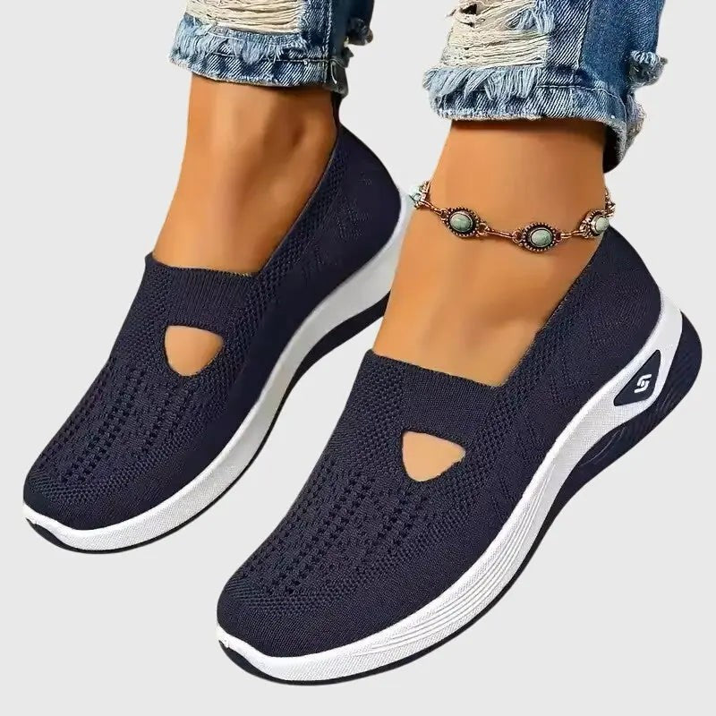 Navy blue knit slip-on sneakers with cutout detail and platform sole