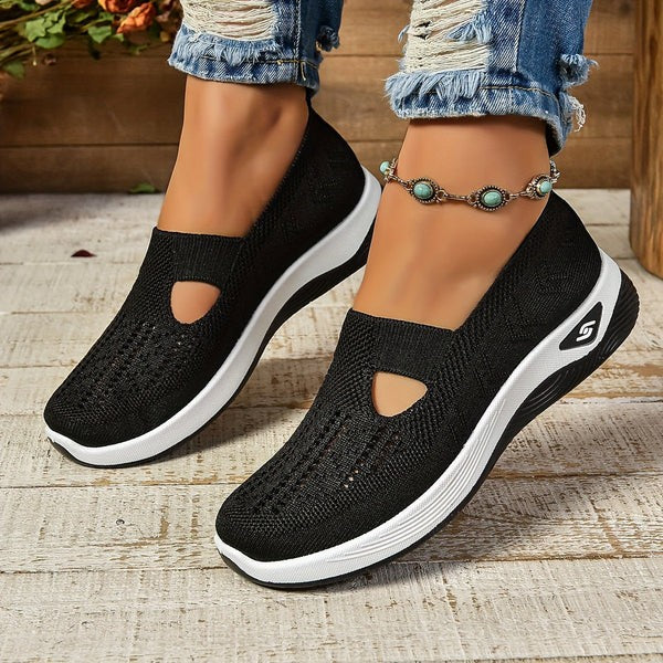 Black knit slip-on sneakers with cutout accent and thick platform sole