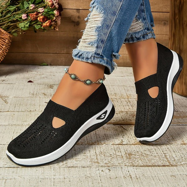 Black mesh slip-on sneakers with cutout design and contrast white outsole