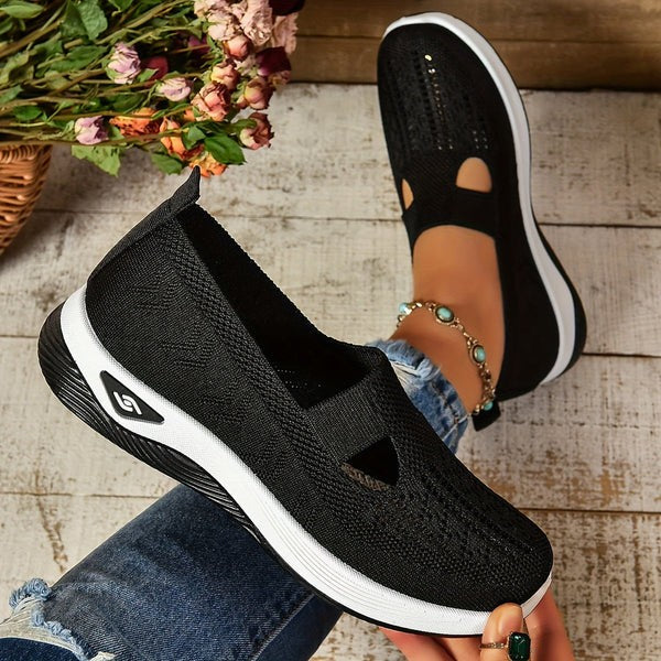 Black knit slip-on sneakers displayed with cutout detail and chunky sole