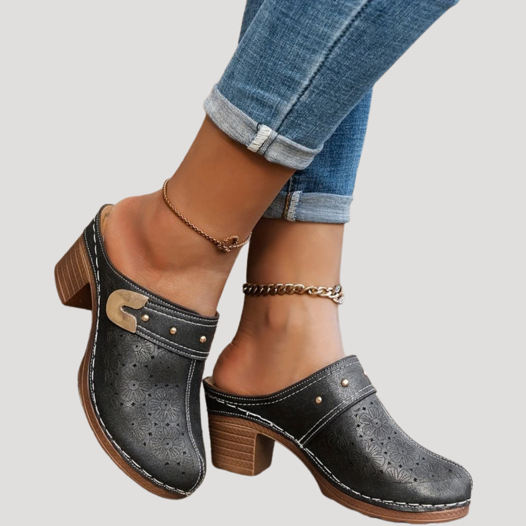 Black leather clog mules with floral cutout design and stacked block heel