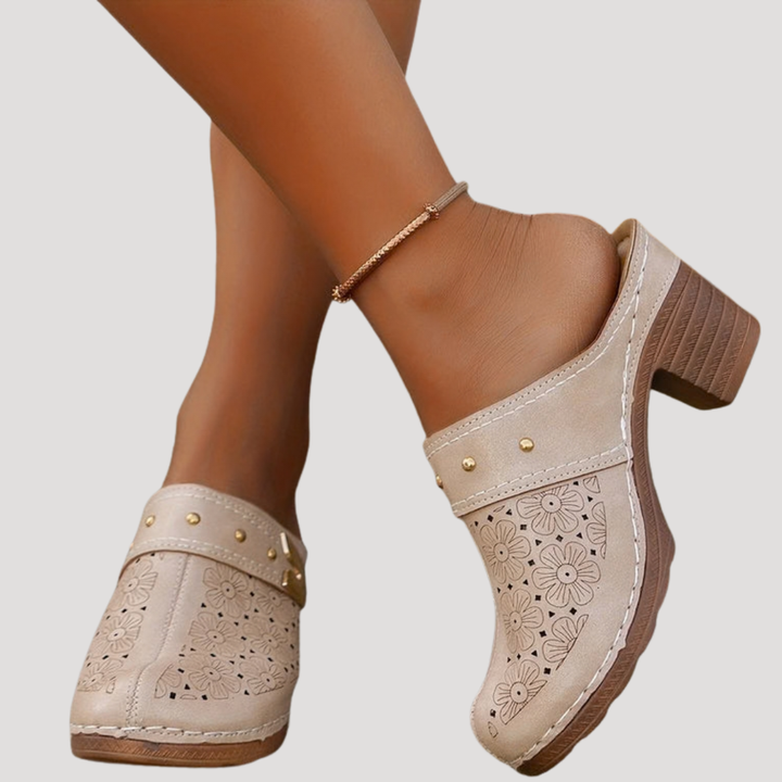 beige studded clog mules with perforated flower design and mid block heel